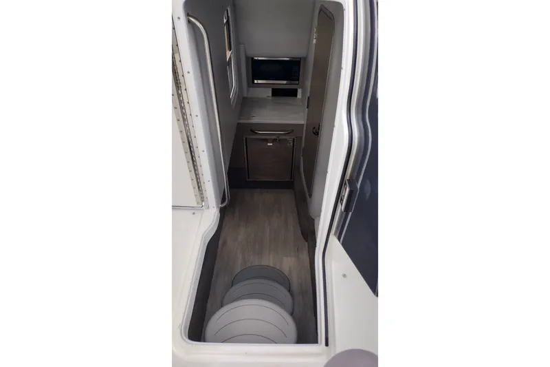 Slide: The Image of Interior view of 2026 Formula 350 Crossover Bowrider, featuring modern kitchenette and sleek design. - 37