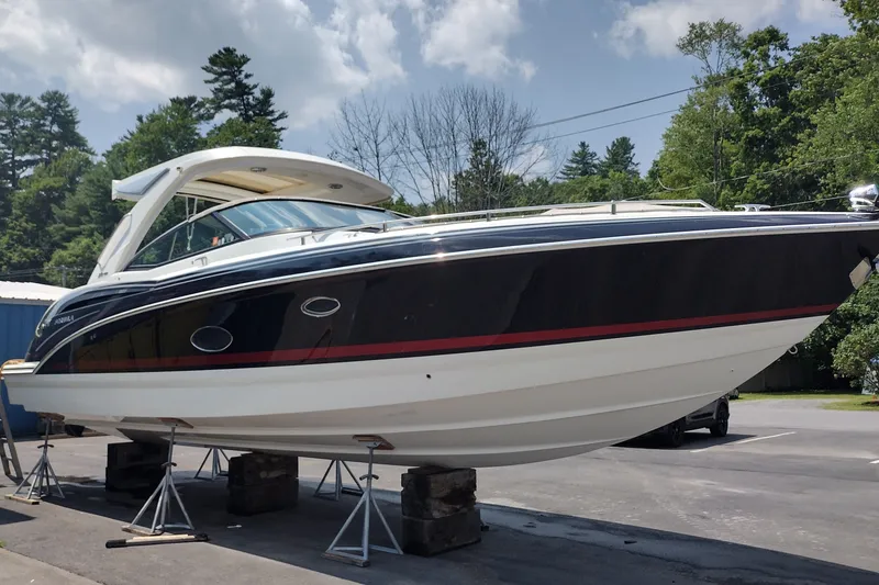Slide: The Image of 2026 Formula 350 Crossover Bowrider on stands, sleek design, outdoors, sunny day. - 4
