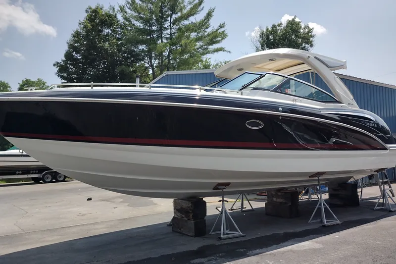 Slide: The Image of 2026 Formula 350 Crossover Bowrider boat on stands, outdoors, under clear sky. - 6