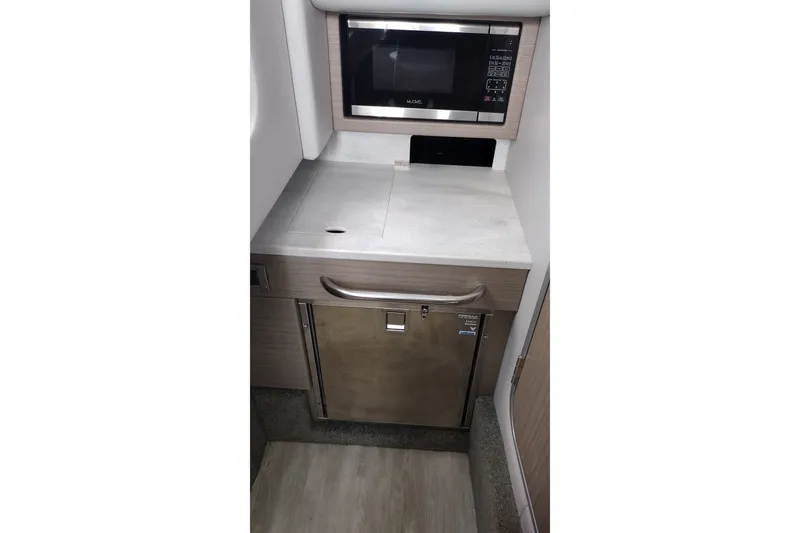 Slide: The Image of 2026 Formula 350 Crossover Bowrider kitchenette with microwave and compact fridge. - 38