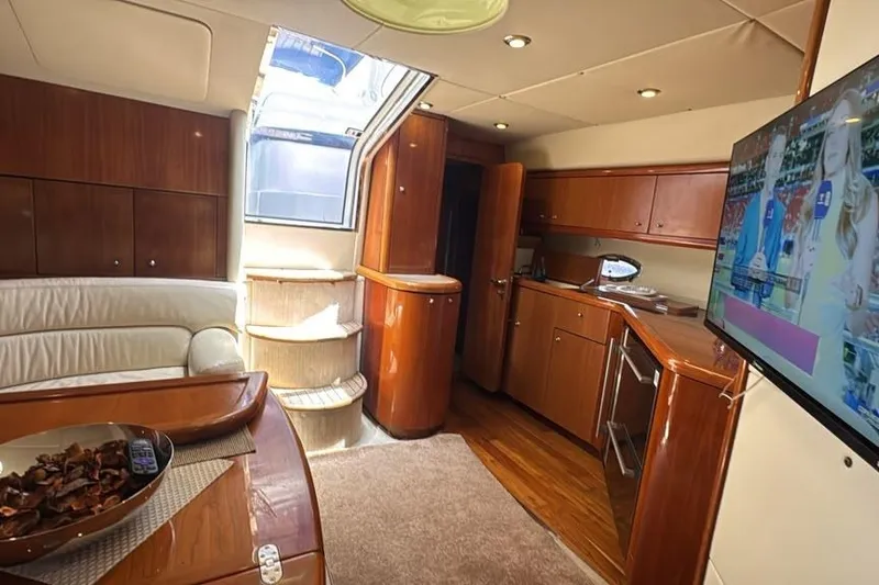 Slide: The Image of Luxurious interior of 2003 Sunseeker Portofino 46 yacht with modern amenities and elegant wood finishes. - 25