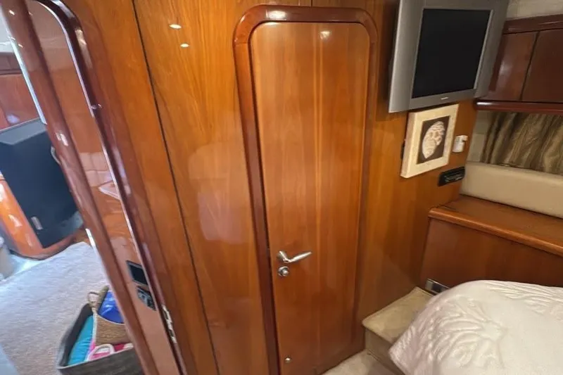 Slide: The Image of Interior of 2003 Sunseeker Portofino 46 yacht with wooden door and mounted TV. - 13