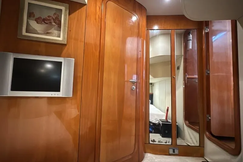 Slide: The Image of Interior of 2003 Sunseeker Portofino 46 yacht with wood paneling and mounted TV. - 21
