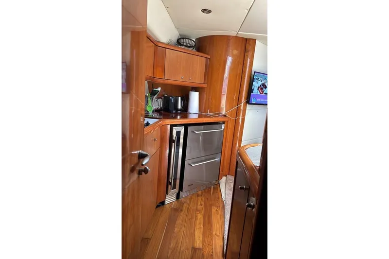 Slide: The Image of Luxurious wooden interior of 2003 Sunseeker Portofino 46 yacht kitchen area. - 24