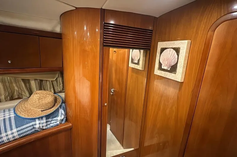 Slide: The Image of Interior of 2003 Sunseeker Portofino 46 yacht with wood paneling and decorative shell art. - 18