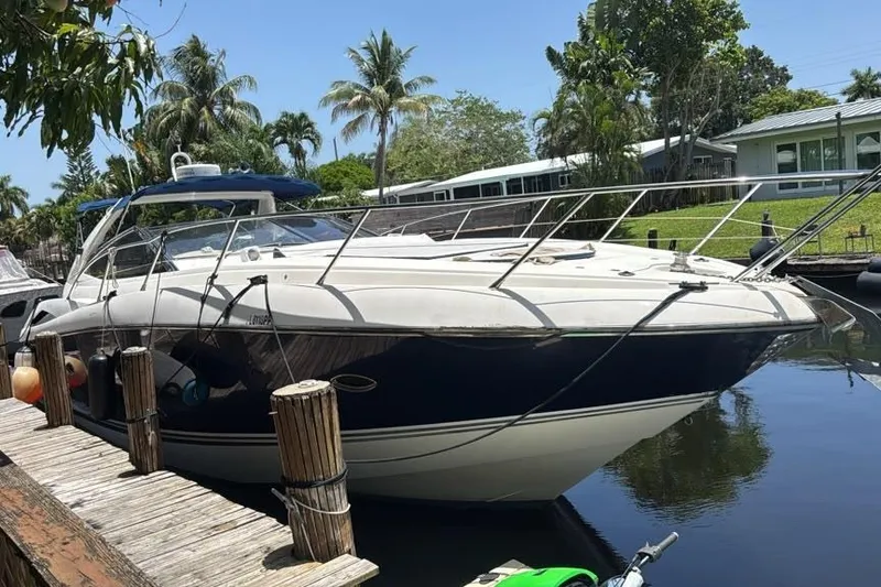 The Image of 2003 Sunseeker Portofino 46 yacht docked by a tropical waterfront. - 0