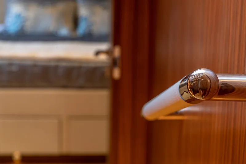 Slide: The Image of Interior detail of 2023 Sirena Flybridge yacht, featuring polished wood and metal accents. - 42