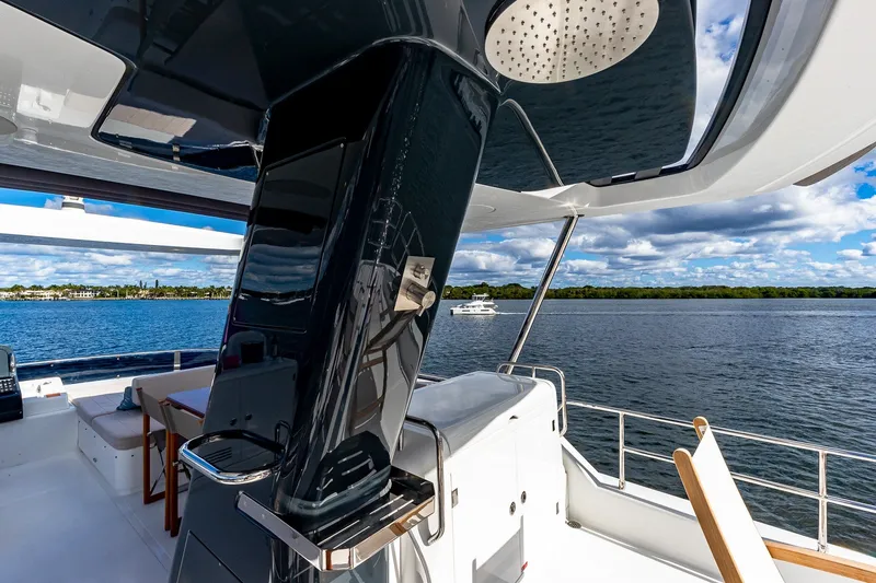 Slide: The Image of 2023 Sirena Flybridge yacht with sleek design, overlooking serene waters and blue sky. - 26
