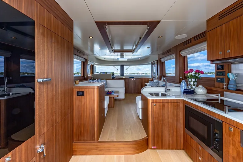 Slide: The Image of Luxurious interior of 2023 Sirena Flybridge yacht with modern kitchen and elegant wood finishes. - 32