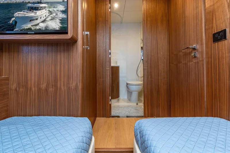 Slide: The Image of Interior of 2023 Sirena Flybridge yacht with twin beds and bathroom. - 56