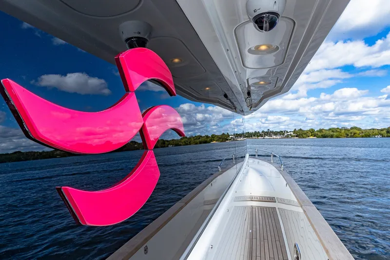 Slide: The Image of 2023 Sirena Flybridge yacht cruising on a serene lake under a partly cloudy sky. - 17