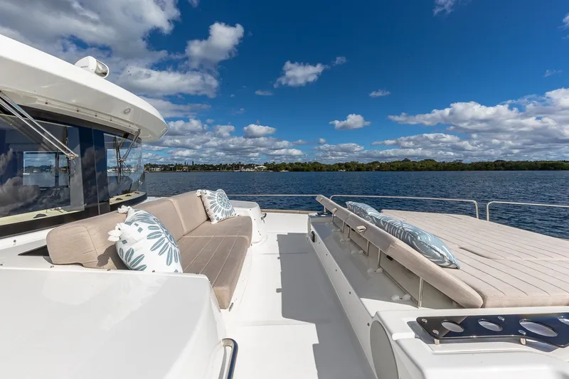 Slide: The Image of Luxurious 2023 Sirena Flybridge yacht with elegant seating, cruising on a serene lake. - 20