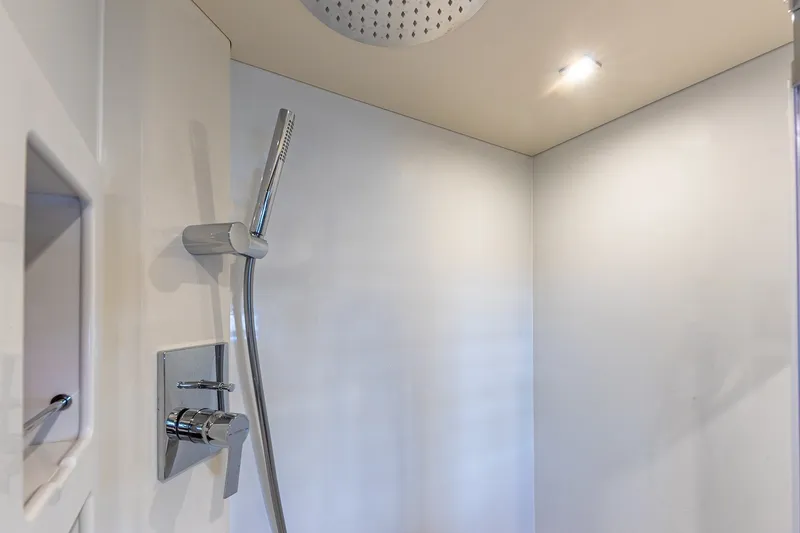 Slide: The Image of Modern shower area in 2023 Sirena Flybridge yacht, featuring sleek chrome fixtures. - 48