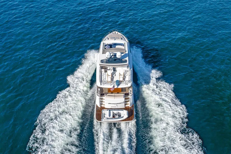 Slide: The Image of 2023 Sirena Flybridge yacht cruising on open blue waters, aerial view. - 11
