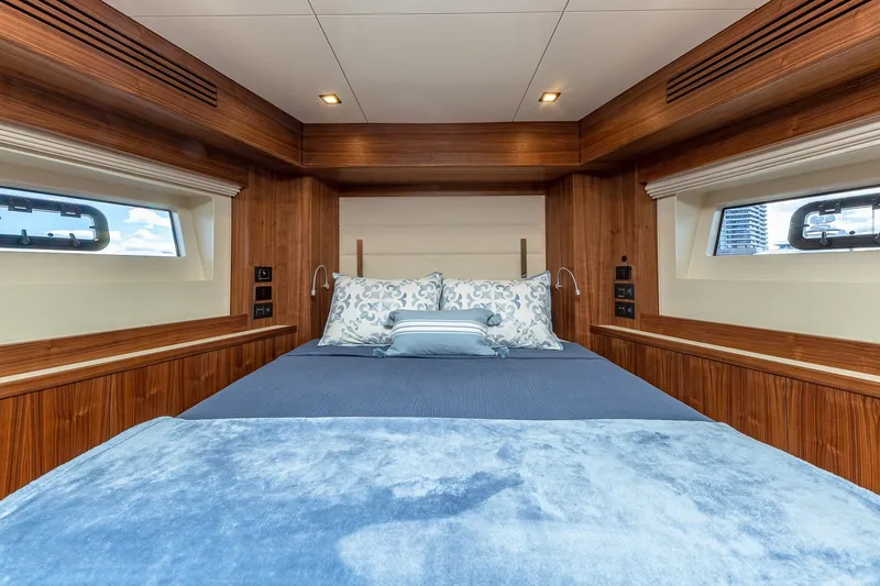 Slide: The Image of Luxurious cabin interior of 2023 Sirena Flybridge yacht with elegant bedding and wood accents. - 50