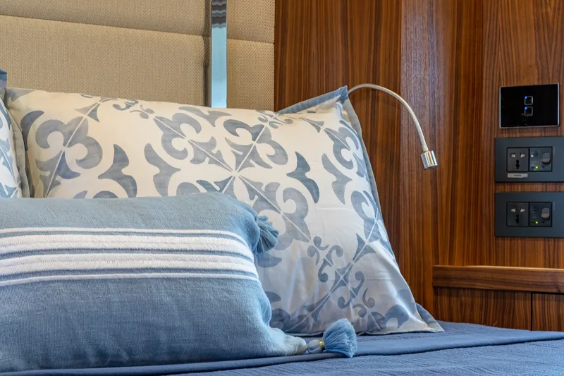Slide: The Image of Luxurious 2023 Sirena Flybridge yacht bedroom with elegant pillows and modern wood paneling. - 51