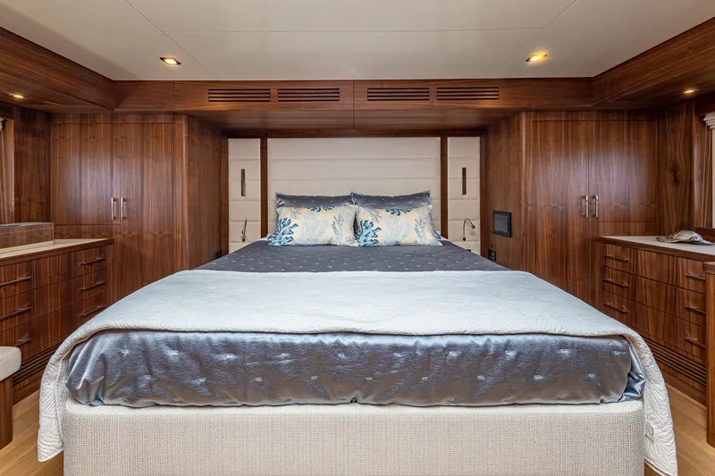 Slide: The Image of Luxurious 2023 Sirena Flybridge yacht bedroom with elegant wood paneling and plush bedding. - 43