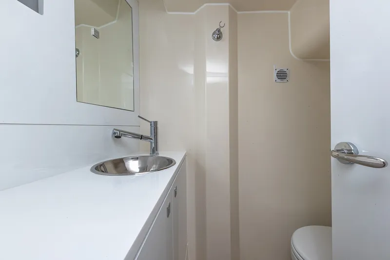 Slide: The Image of Modern bathroom interior on 2023 Sirena Flybridge yacht, featuring sleek sink and mirror. - 64