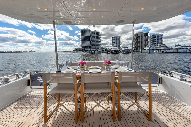 Slide: The Image of Luxurious 2023 Sirena Flybridge yacht dining area with waterfront cityscape view. - 14