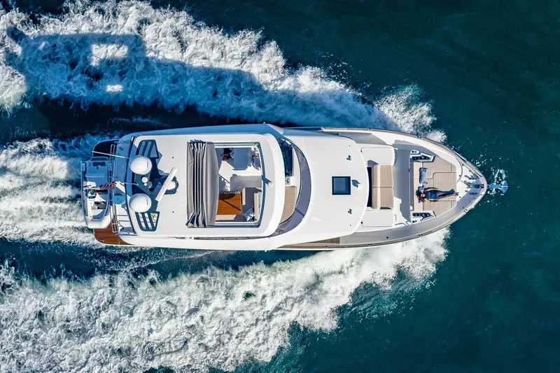 Slide: The Image of Aerial view of 2023 Sirena Flybridge yacht cruising on open water. - 12