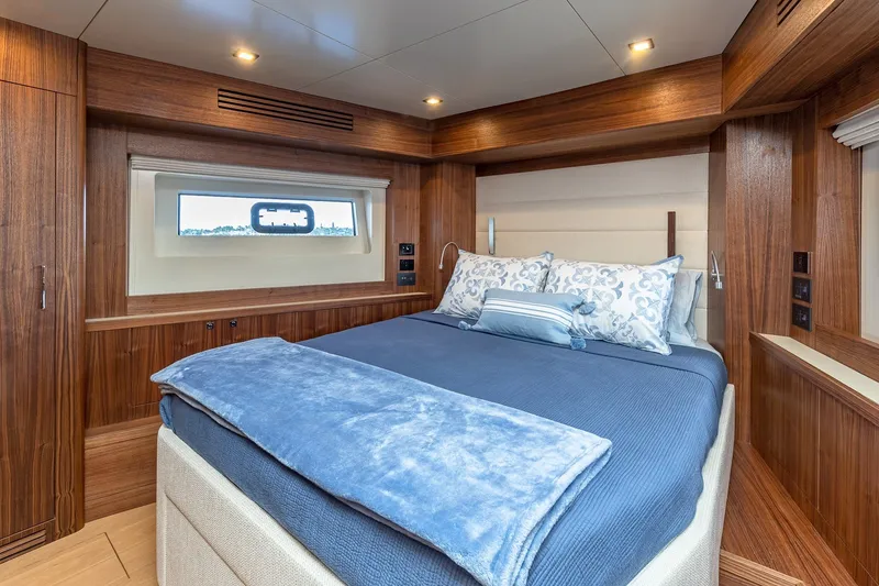 Slide: The Image of Luxurious cabin interior of 2023 Sirena Flybridge yacht with elegant bedding and wood paneling. - 49