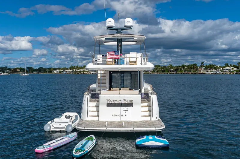 Slide: The Image of 2023 Sirena Flybridge yacht on water with paddleboards and inflatable dock. - 6
