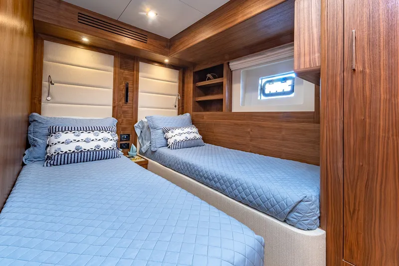Slide: The Image of Luxurious 2023 Sirena Flybridge yacht cabin with twin beds and elegant wood paneling. - 54