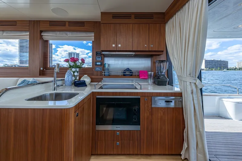 Slide: The Image of Luxurious 2023 Sirena Flybridge yacht kitchen with modern appliances and scenic water view. - 33