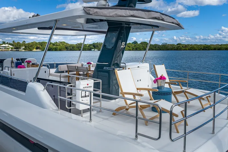Slide: The Image of 2023 Sirena Flybridge yacht with elegant deck chairs and scenic water view. - 24