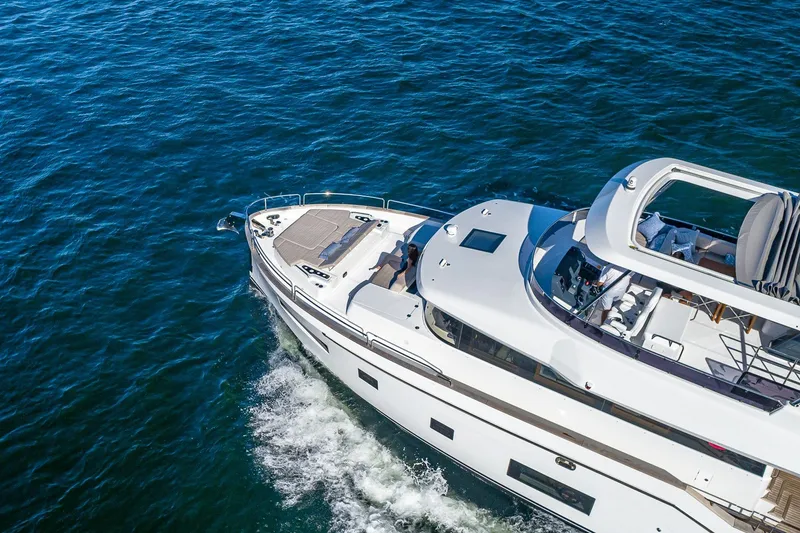 Slide: The Image of Aerial view of 2023 Sirena Flybridge yacht cruising on open water. - 10