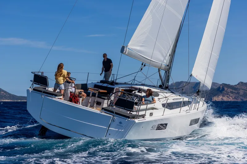 Slide: The Image of 2026 Jeanneau Sun Odyssey 455 sailing on open sea with crew onboard. - 1