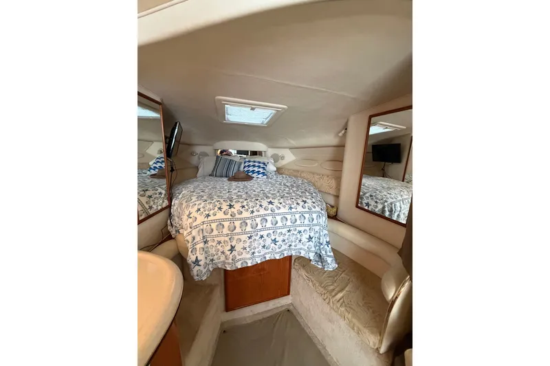 Slide: The Image of Interior cabin of 2000 Sea Ray 340 Sundancer with cozy bed and nautical decor. - 20