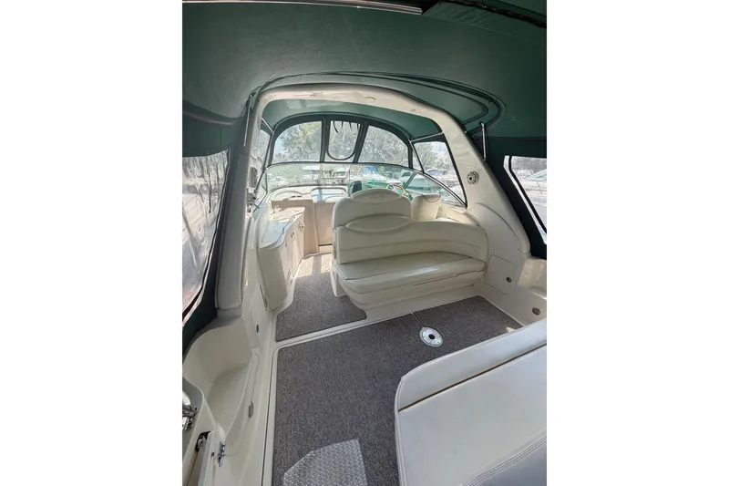 Slide: The Image of Interior of a 2000 Sea Ray 340 Sundancer boat, featuring seating and helm area. - 4