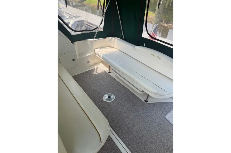 Slide: The Image of Interior view of 2000 Sea Ray 340 Sundancer boat with white seating and carpeted floor. - 5