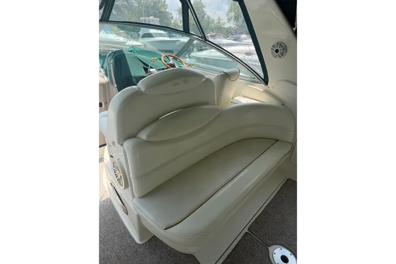 Slide: The Image of Interior seating of a 2000 Sea Ray 340 Sundancer boat, featuring plush white upholstery. - 6