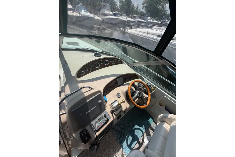 Slide: The Image of Cockpit view of 2000 Sea Ray 340 Sundancer yacht with steering wheel and controls. - 10