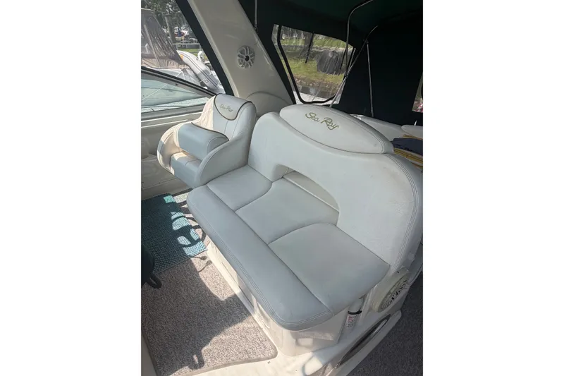 Slide: The Image of Interior seating of a 2000 Sea Ray 340 Sundancer boat, featuring white leather upholstery. - 8