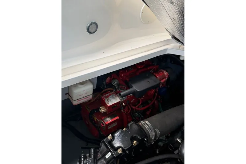Slide: The Image of Engine compartment of a 2000 Sea Ray 340 Sundancer boat, showcasing mechanical components. - 22