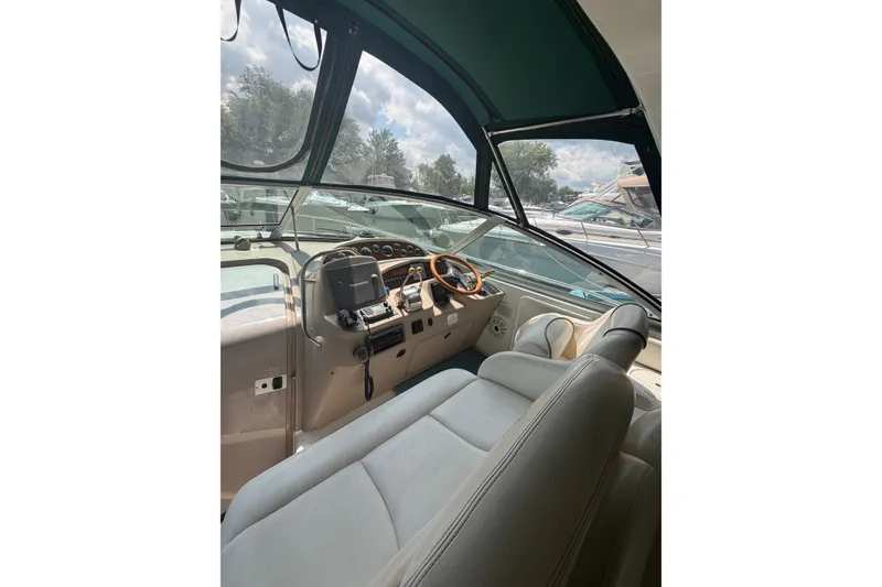 Slide: The Image of Cockpit of 2000 Sea Ray 340 Sundancer with steering wheel and navigation equipment. - 7