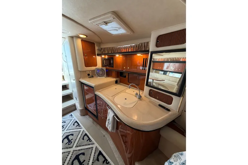 Slide: The Image of Interior of 2000 Sea Ray 340 Sundancer yacht with kitchenette and wood cabinetry. - 17