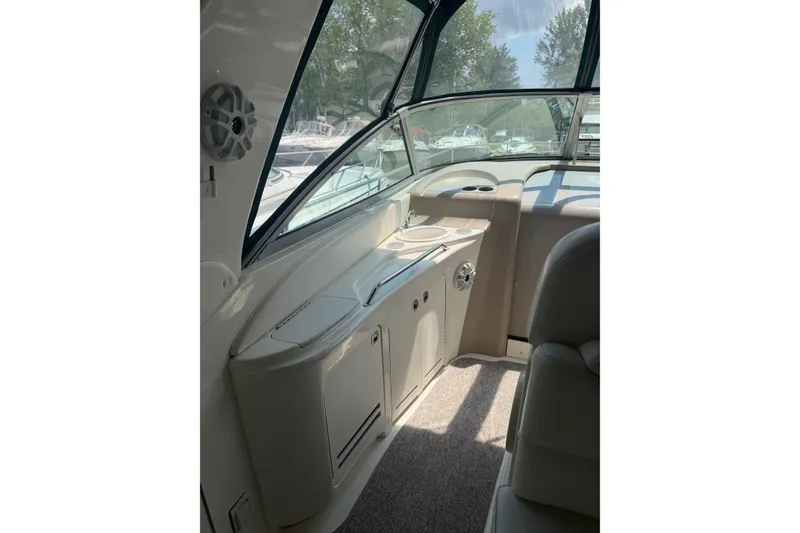 Slide: The Image of Interior view of 2000 Sea Ray 340 Sundancer boat, featuring helm and seating area. - 9