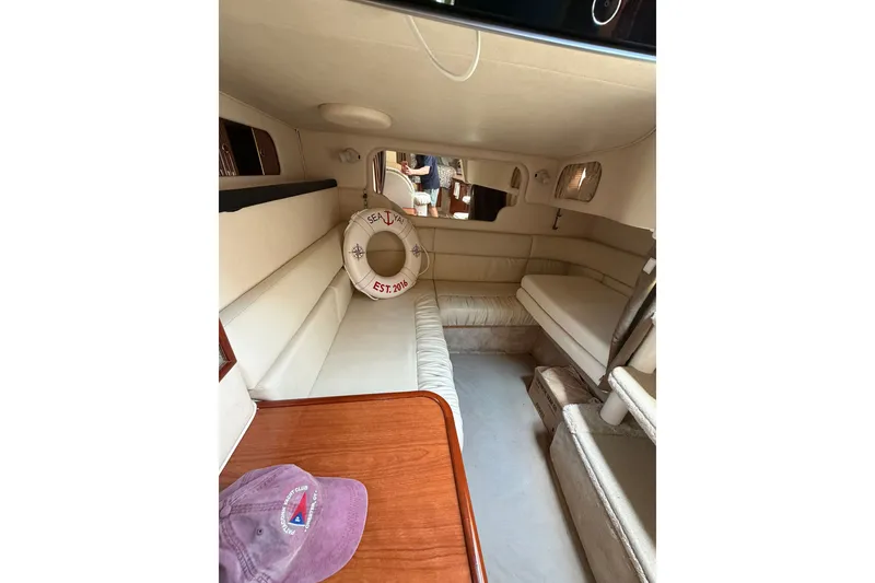 Slide: The Image of Interior of 2000 Sea Ray 340 Sundancer yacht with beige seating and wooden table. - 18