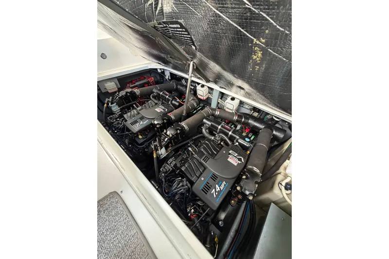 Slide: The Image of Engine compartment of a 2000 Sea Ray 340 Sundancer boat, featuring dual 7.4 MPI engines. - 25