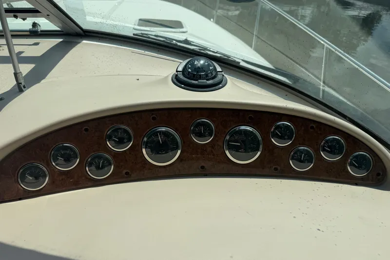 Slide: The Image of Dashboard of a 2000 Sea Ray 340 Sundancer boat with gauges and compass. - 14