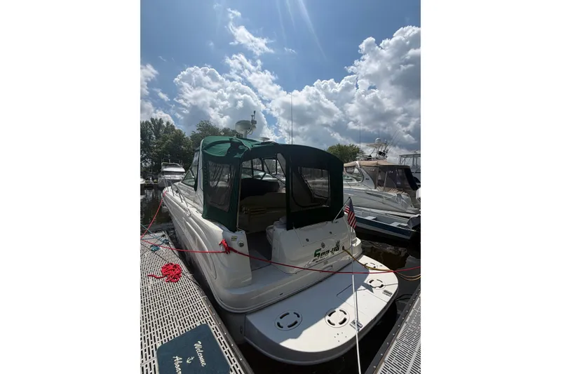 Slide: The Image of 2000 Sea Ray 340 Sundancer docked under a partly cloudy sky. - 3