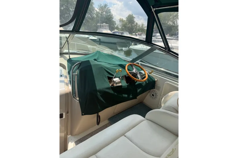 Slide: The Image of Interior of a 2000 Sea Ray 340 Sundancer boat with covered helm and steering wheel. - 15