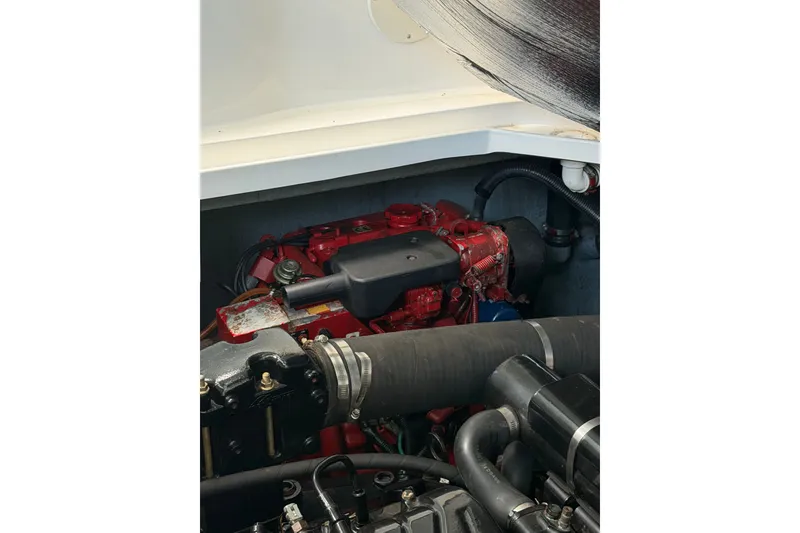 Slide: The Image of Engine compartment of a 2000 Sea Ray 340 Sundancer boat, showcasing mechanical components. - 26