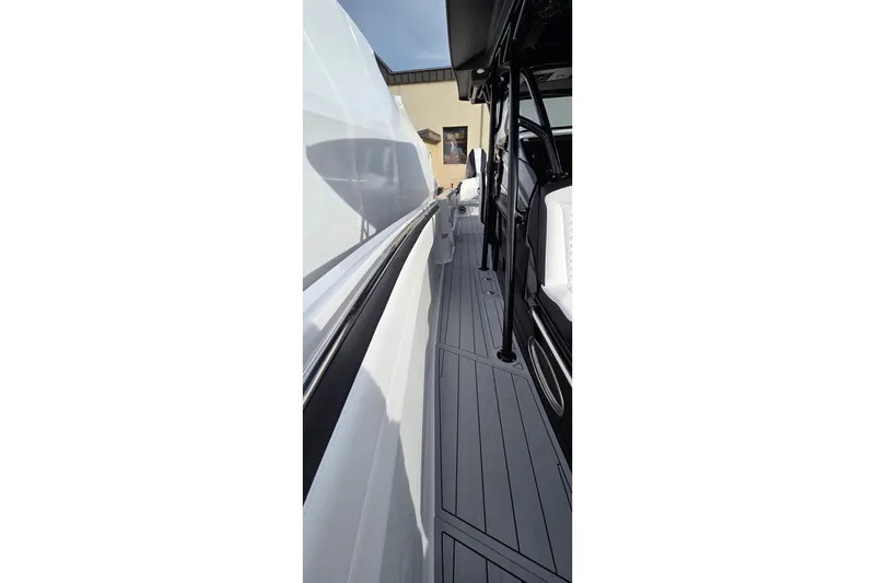 Slide: The Image of 2026 Nor-Tech 390 Sport Center Console, sleek side view with modern design. - 13