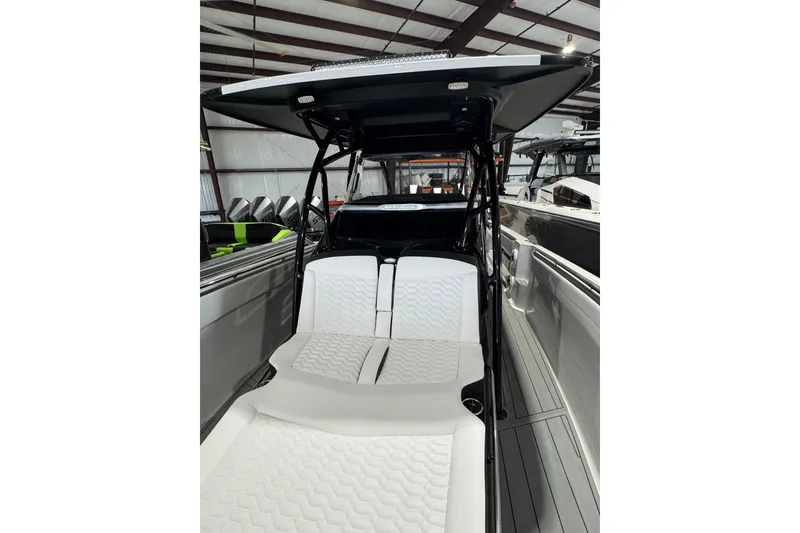 Slide: The Image of 2026 Nor-Tech 390 Sport Center Console with sleek design and comfortable seating in a showroom. - 6
