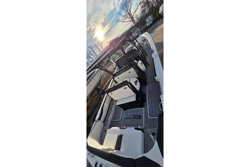 Slide: The Image of 2026 Nor-Tech 390 Sport Center Console boat interior with seating and deck, under a bright sky. - 7